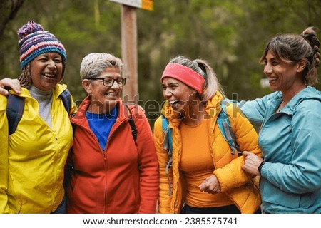 Multiracial women having fun together during trekking day in the forest - Female community and sport concept Royalty-Free Stock Photo #2385575741