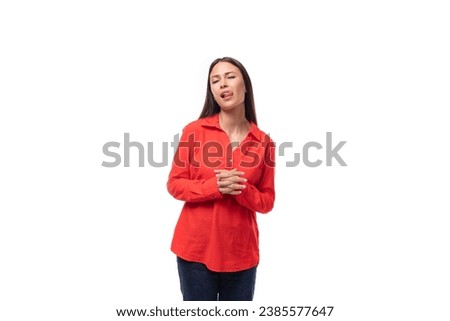 charming young business woman with black hair dressed in a loose red shirt on a white background with copy space