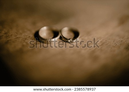 Wedding rings, a special symbol of marriage. A pair of wedding rings on a wooden background.