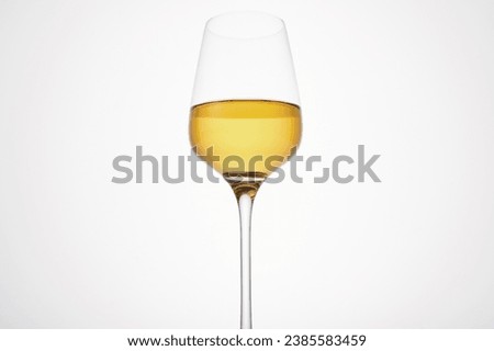 White wine fills half glass. Champagne flute. Royalty-Free Stock Photo #2385583459