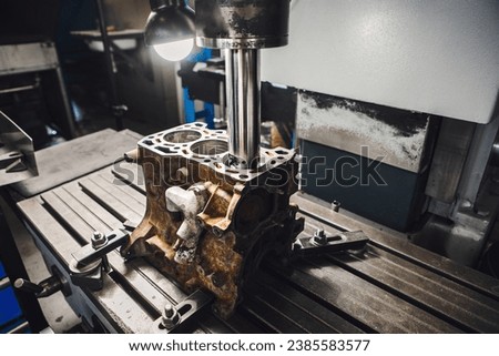 Engine cylinder boring on cnc machine. Boring under the piston after engine sleeve using machine with Computer Numerical Control. Royalty-Free Stock Photo #2385583577