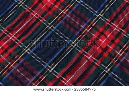 close-up texture tartan scottish style checkered fabric green, red and blue colors tilted. Image for your design Royalty-Free Stock Photo #2385584975