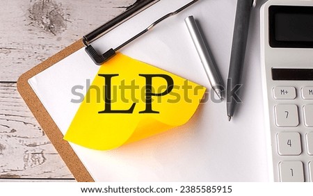 LP word on yellow sticky with calculator, pen and clipboard
