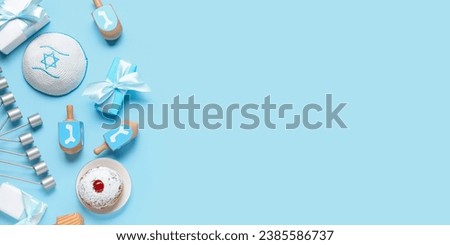 Composition for Hanukkah celebration on light blue background with space for text