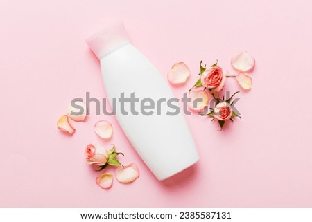 Fancy healthcare bottles for cream with rose flower. Natural oranic spa cosmetics concept. Mockup, template, Top view. Royalty-Free Stock Photo #2385587131
