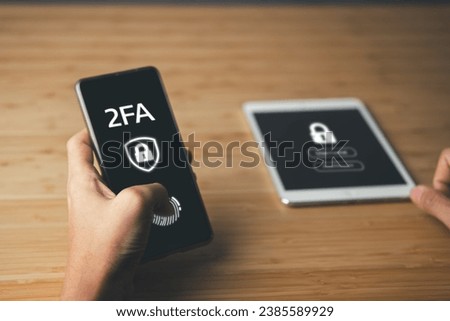 Business man use mobile phone with security icon and 2FA screen.Cloud computing internet network communication and Data Security system concept.