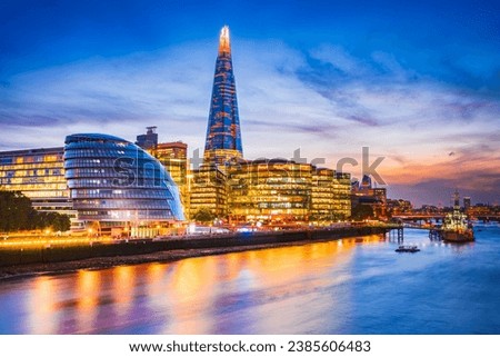 London, United Kingdom. Skyline view of the famous New London, City Hall and Shard, golden sunset hour. View includes Thames River, skyscrapers, office buildings and beautiful sky. Royalty-Free Stock Photo #2385606483