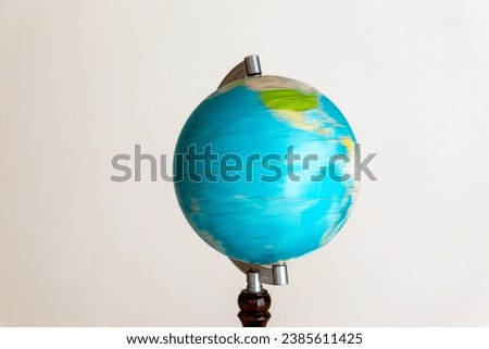 Blue globe rotating at high speed Royalty-Free Stock Photo #2385611425