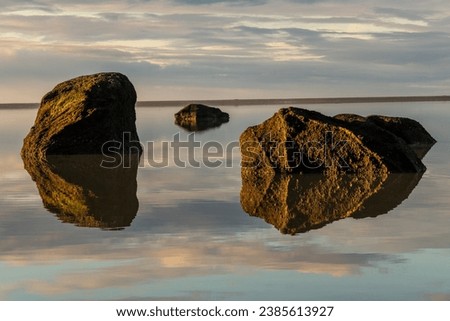 Iceland Abstract Optical Illusion. Volcanic Rocks Floating in the Water or Suspended in the Sky