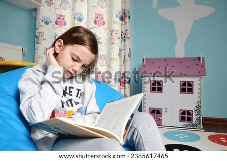 Cute girl in school uniform having video conference from home using laptop and writing in notebook. Back to school or online education concept. High quality photo