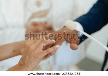 Just married. Close up picture of bride putting ring on her husbands finger. Eternity love. Church marriage. Close up picture