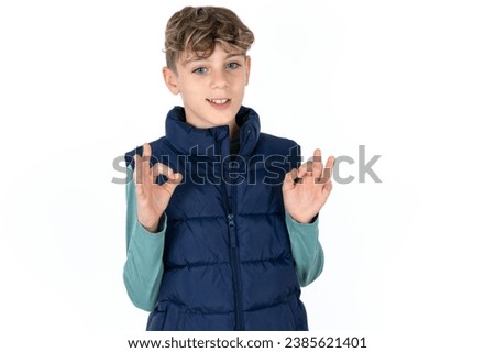 Caucasian teen boy showing both hands with fingers in OK sign. Approval or recommending concept