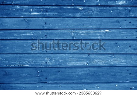 Wooden log house wall texture in navy blue tone. Abstract architectural background and texture for design.