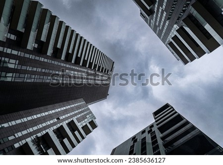 styles and facades of modern buildings in Europe on a sunny day, with clouds and perspective from below