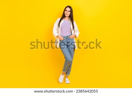 Full length photo of pleasant adorable woman dressed white jacket jeans holding palms in pockets isolated on yellow color background