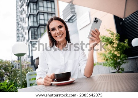 Photo of attractive elegant person enjoy aroma coffee use smart phone chatting street cafe terrace outdoors