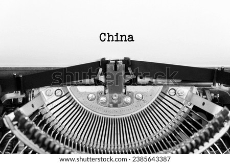 China phrase closeup being typing and centered on a sheet of paper on old vintage typewriter mechanical