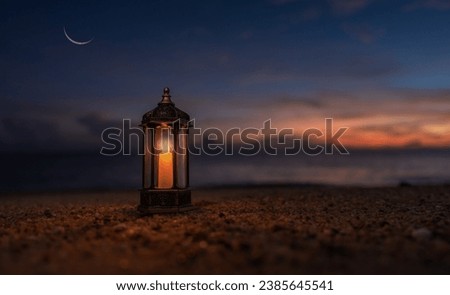 Lantern candle on sand beach twilight sunset sky and crescent moon, Religion of Islamic well free space for text Ramadan Kareem, Eid Al Adha, Eid Al Fitr, Mubarak  Royalty-Free Stock Photo #2385645541