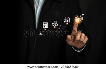Businessman pointing business goal  with business plan and strategy icon for achieving goals, Start up business and success .
