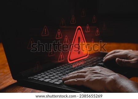 IT staff, programmers, developers use computer with warning triangle sign for error notification and maintenance concept. System error warning pop-up