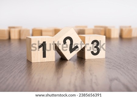 123 text on wooden cubes . wooden background. foreground