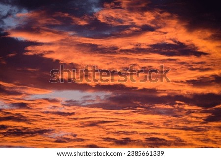 The sky with orange clouds when the sun is about to set or near dusk.