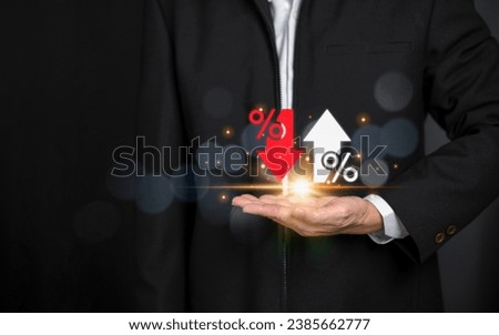 Businessman showing percentage icons up and down red arrow icons with graph indicators. Concept of financial interest rates and mortgage rates. Interest Rates Stocks Finance Ratings Mortgage Rates.