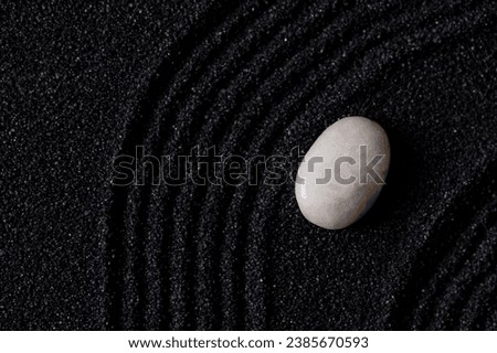 Zen Garden with White stone on Black Sand Wave Pattern in Japanese stye, Rock Sea Stone on Sand texture with the wave parallel lines pattern,Harmony,Meditation,Zen like concept