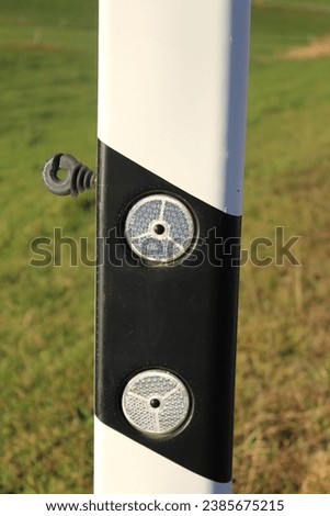 Delineator posts with reflectors for road safety.
