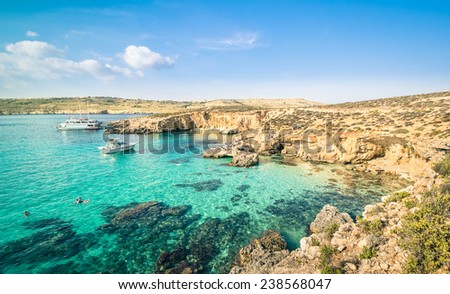 The world famous Blue Lagoon in Comino island - Mediterranean nature wonder in the beautiful Malta - Unrecognizable international tourist people and snorkeling divers - Exclusive travel destinations Royalty-Free Stock Photo #238568047