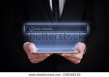 Businessman holding a tablet with the projection browser line above the screen. business concept. Internet concept. search. Web surfing.
