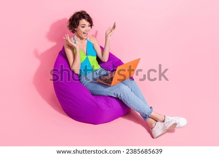 Full body cadre of girl sitting comfortable bean bag shocked looking how much tasks she got look laptop isolated on pink color background