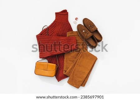 Fashion autumnal outfit. Knitted brown sweater with loafers, pants and handbag. Women's warm jumper, stylish autumn or winter clothes. Cozy fall look. Flat lay, top view, overhead.