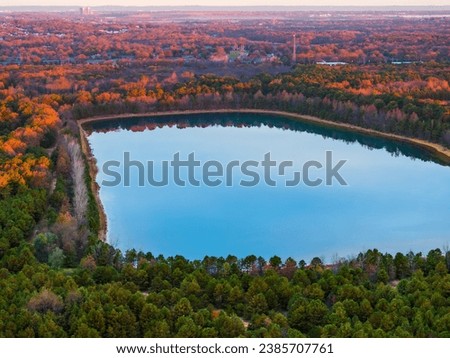 Fall colors surrounding a lake from an aerial view