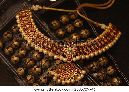 temple jewelry, kundan jewellery, dance related accessories isolated on dark background