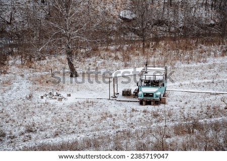 Bus in the forest, tourist camping equipped with old passenger transport, winter recreation center, landscape, top view of the cottage, camping in the forest. High quality photo