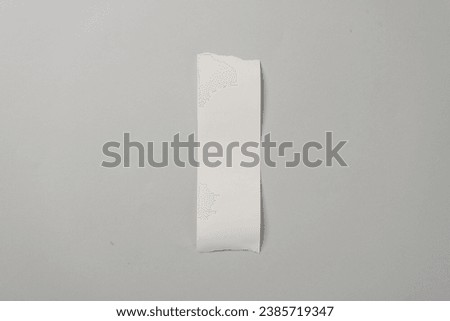Blank Cash Receipt Sales Check on gray background Royalty-Free Stock Photo #2385719347
