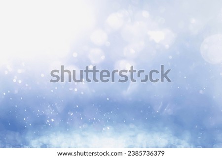 COLD BLUE WINTER BACKGROUND WITH SPARKLING BOKEH LIGHTS AND GLITTERING ICE ON THE GROUND, BACKDROP FRO CHRISTMAS OR WINTER MONTAGE