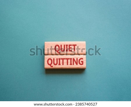 Quiet quitting symbol. Concept word Quiet quitting on wooden blocks. Beautiful grey green background. Business and Quiet quitting concept. Copy space.