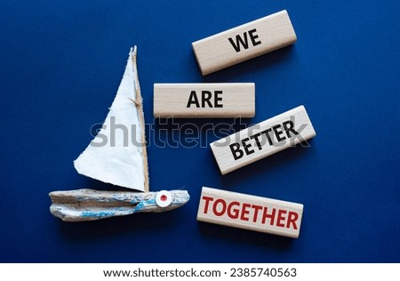 We are stronger together symbol. Wooden blocks with words We are stronger together. Beautiful deep blue background with boat. We are stronger together concept. Copy space.