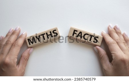 Facts or Myths symbol. Concept word Facts or Myths on wooden blocks. Businessman hand. Beautiful white background. Business and Facts or Myths concept. Copy space