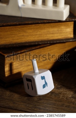 Dreidel is a four-sided top, with which, according to tradition, children play during the Jewish holiday of Hanukkah. The Hebrew letter is written on every facet of the dreidl: nun, gimel, hey and pei