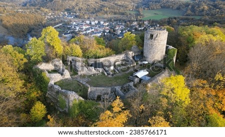 An aerial view of the beautiful ruins of Wlen Castle, in the town of Wlen, Lower Silesia in Poland, at the foot of the Karkonosze Mountains on the Bobr River, in autumn just before sunset.