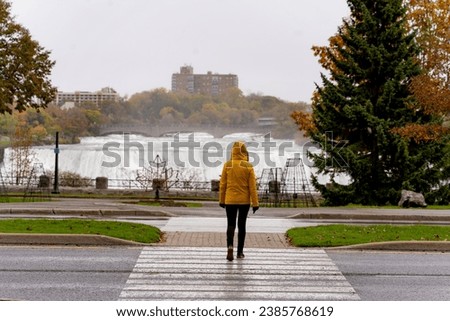 Woman in yellow rain jacket at Niagara Falls