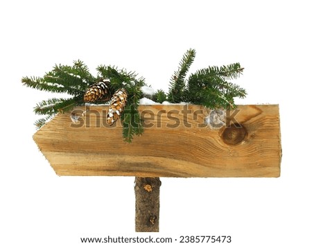 Isolated empty wooden board sign with a Christmas tree branch. Christmas and New Year concept.