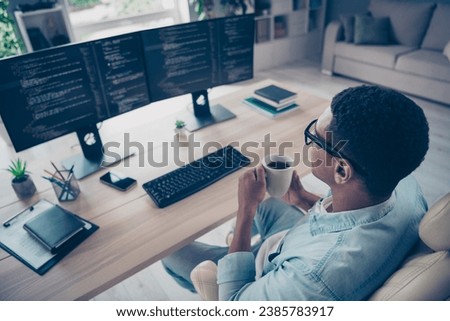 Rear back view photo of young boss man drinking coffee every morning he reviewing his juniors programmers code isolated on home workshop