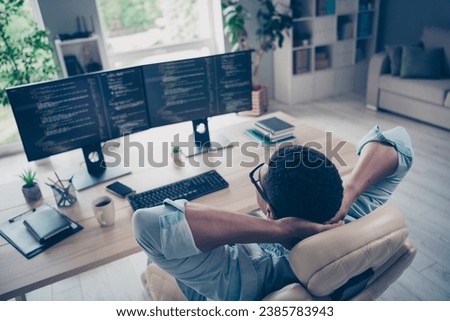 Side view photo of relaxing young funny guy lying comfortable armchair in office while reviewing his website code app indoors workplace Royalty-Free Stock Photo #2385783943