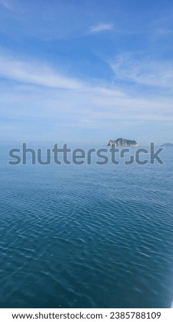 City of Santa Marta, Colombia.  November 1, 2023. Photo of Morro de Santa Marta island.  The sky merges with the sea in blue tones with the contrast of the small island