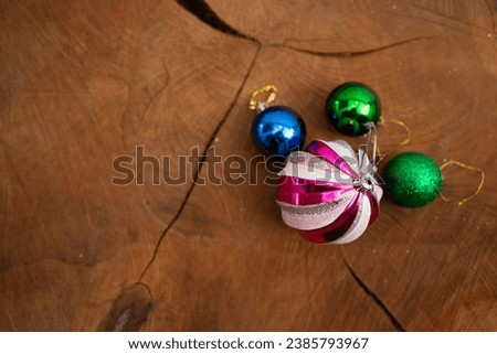 Piles of Christmas Ornaments on a Wooden Background with Text Space