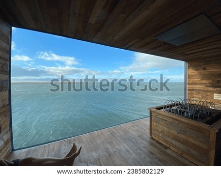 Window at Sky Lagoon sauna. Largest window in Iceland with views of Reykjavik Harbour.  Royalty-Free Stock Photo #2385802129